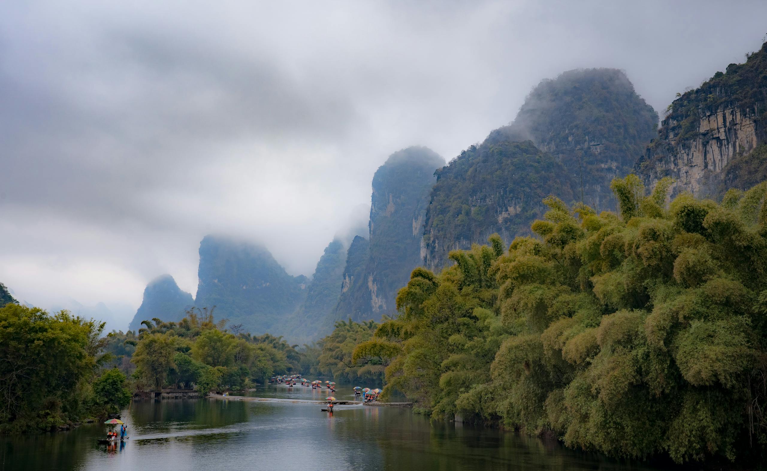 Breathtaking karst mountains in misty Guilin with river and greenery
