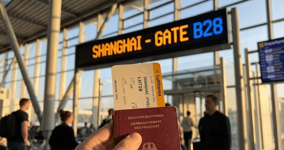 Traveler at departure gate with passport and boarding pass for Shanghai