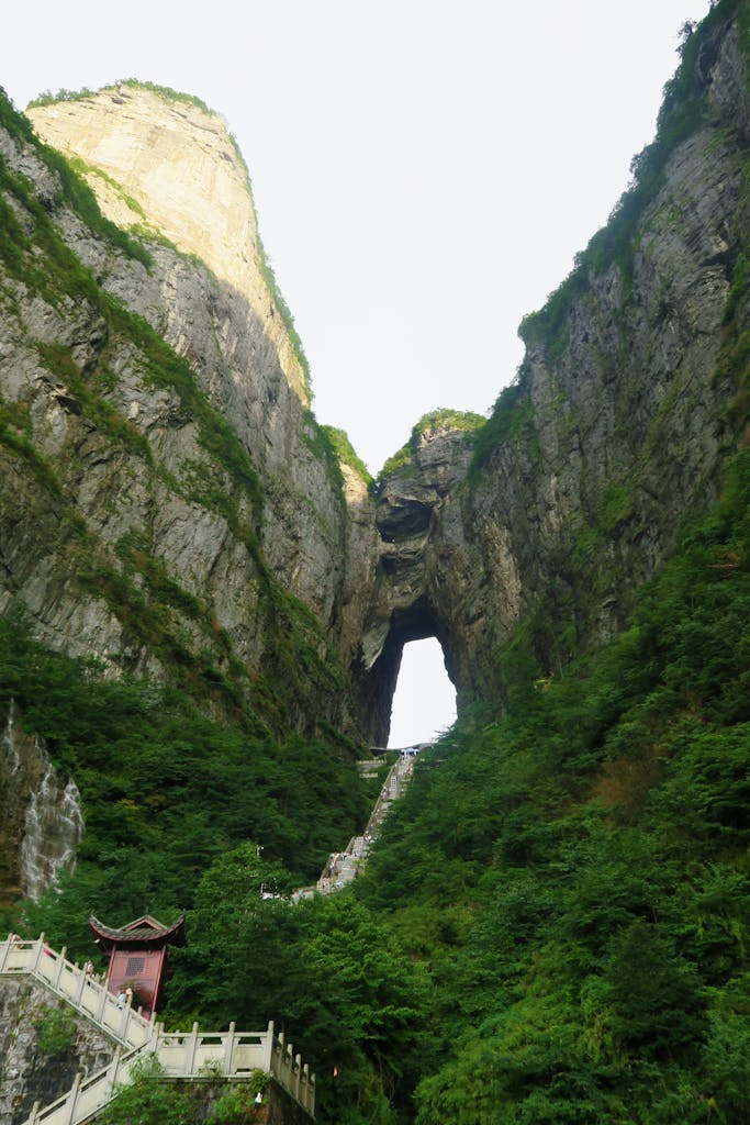 Capture the awe-inspiring view of the famous Tianmen Mountain natural arch in Zhangjiajie, China.