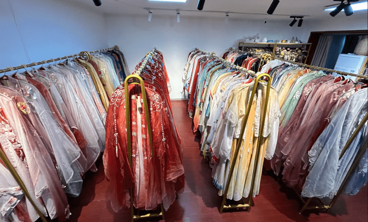 Inside a hanfu rental shop with racks of traditional outfits