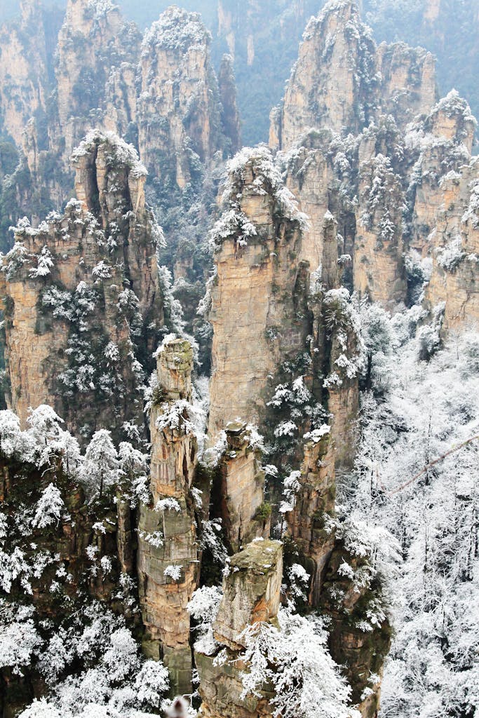 Scenic winter view of snow-covered Tianzi Mountain peaks in Zhangjiajie.
