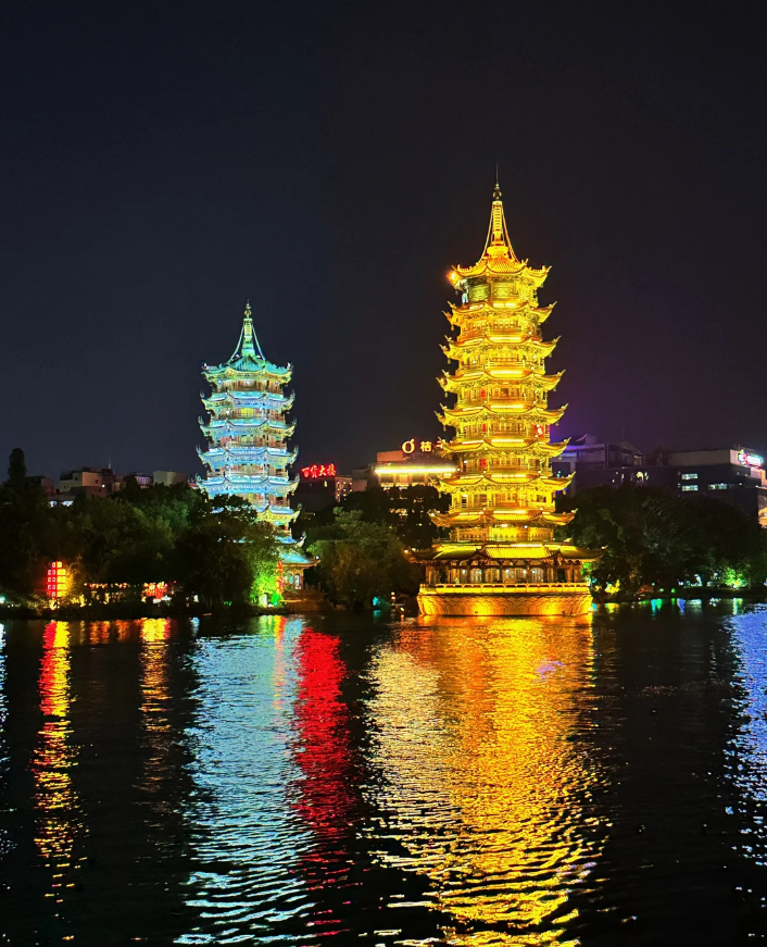 Night view of the Sun and Moon Pagodas reflecting in the lake