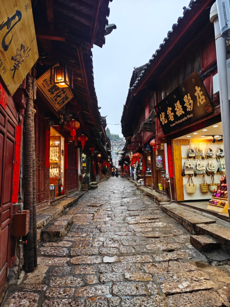 Lijiang Old Town vs Dali Old Town comparison showing slippery stone streets in Lijiang.