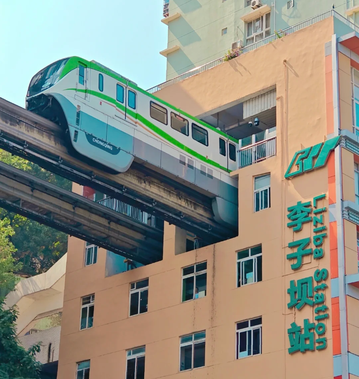 Chongqing CRT train passing through Liziba apartment building.